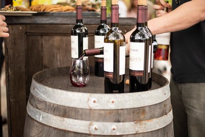 Wine poured in a glass on a barrel