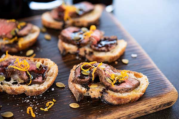 Beef Crostini with Orange Zest and Toasted Pumpkin Seeds