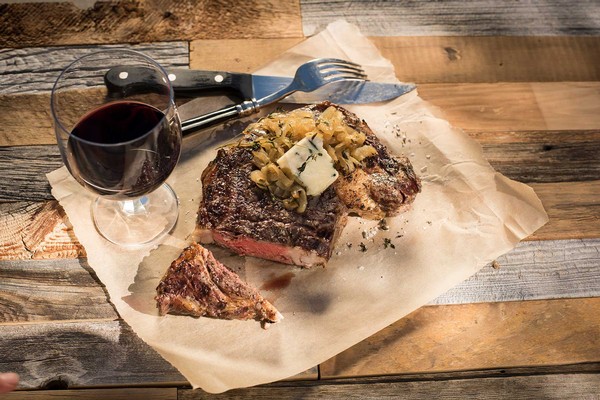 Grilled Rib Eye Steaks with Caramelized Onions and Blue Cheese