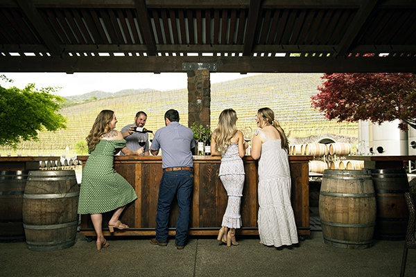 Main Bar Tasting: Woman enjoying wine at bar.