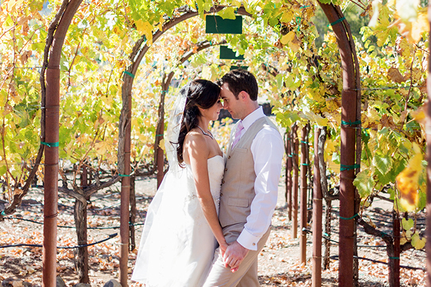 Magnolia Room Venue: Couple holding hands in the vineyard.